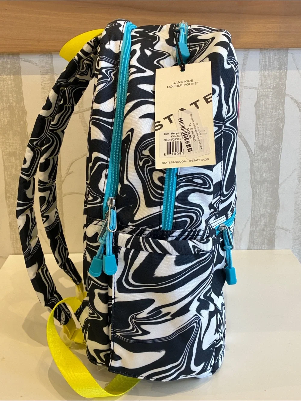 STATE Black & White Swirl Backpack with Pink Logo and Teal Accents